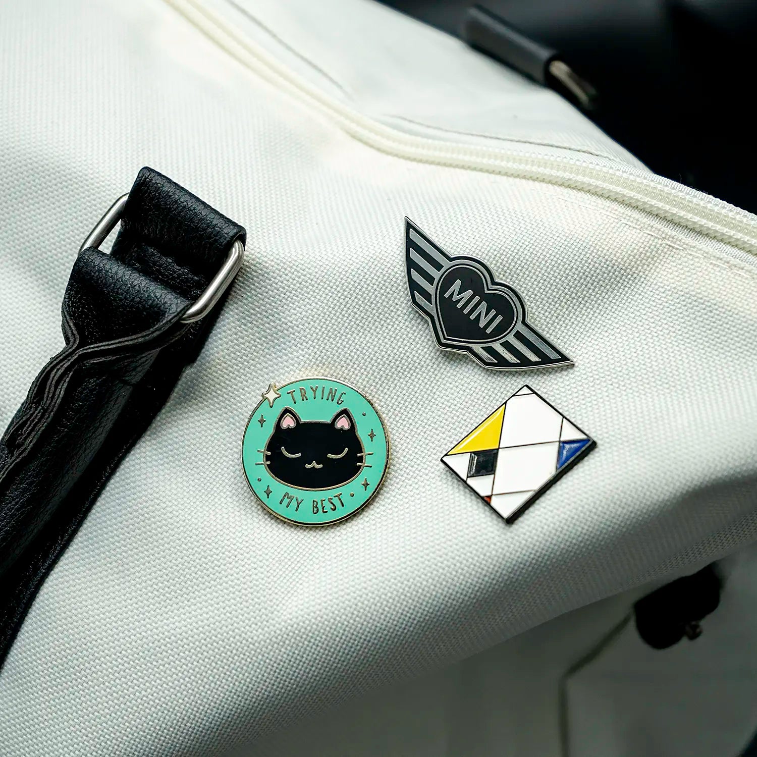 Close-up of a purse with several pins, including the MINI Heart pin.